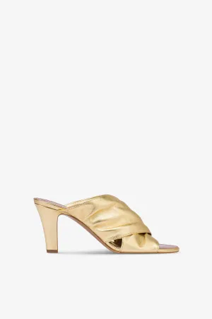 Mules in gold metallic leather